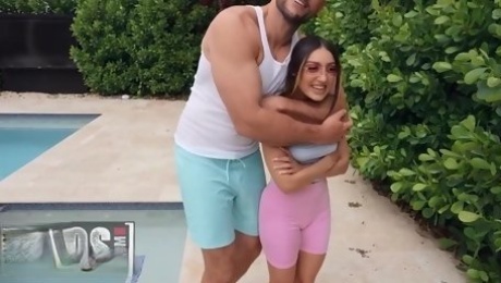 Petite girl and huge man playing naughty by the pool