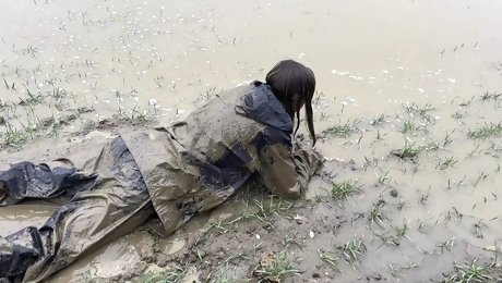 Muddy fields, rain suit in the rain