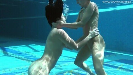 Two tight babes swimming naked together