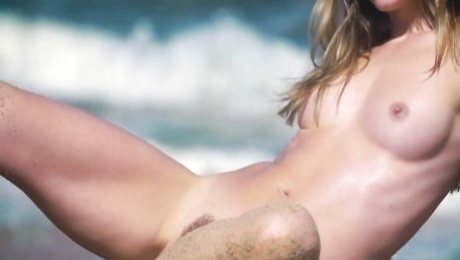 Big-boobed goddess Natalia E poses fully naked on the beach